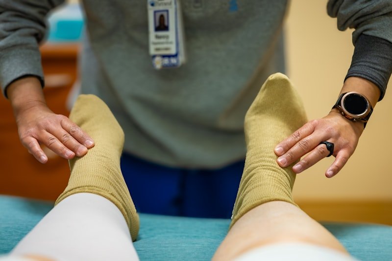 Older adult receiving knee care checkup from a clinician