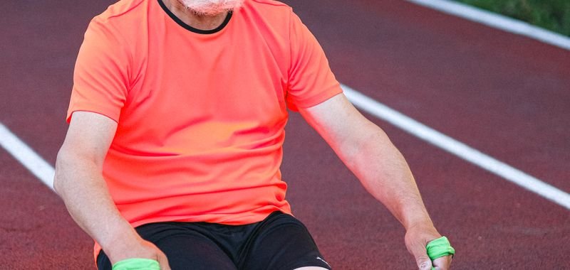 Fit elderly man stretching with a resistance band