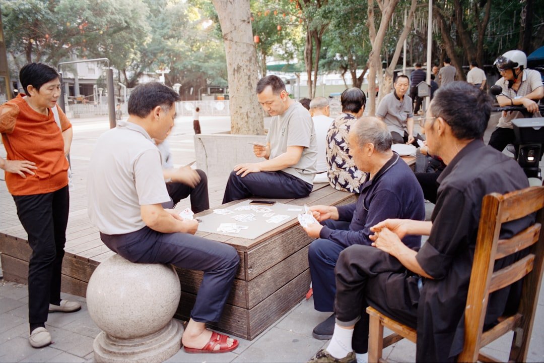 Older adults playing a board game together outdoors