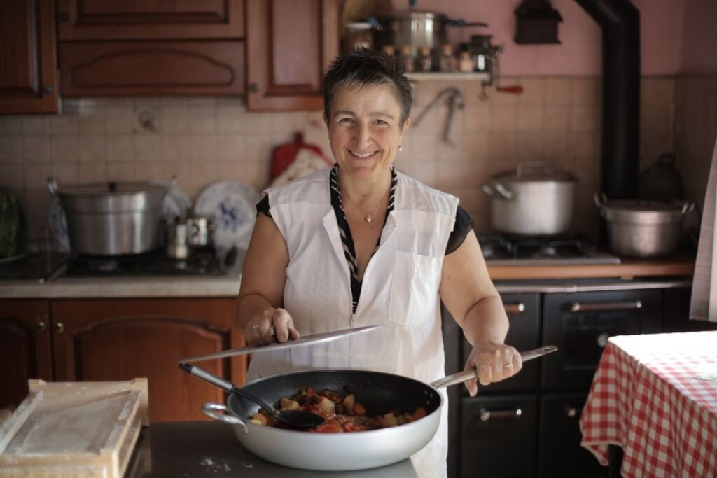 Smiling older woman preparing a home-cooked meal in her kitchen