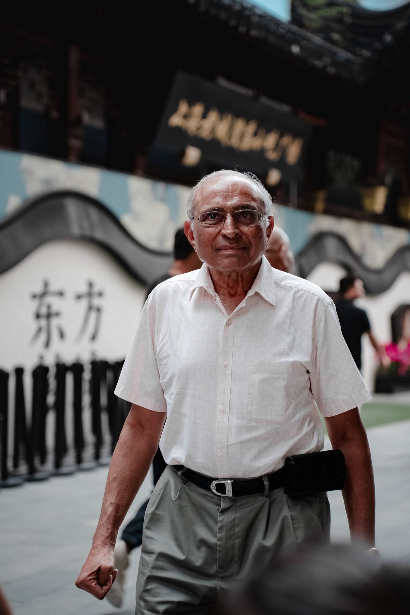 Senior man walking through a traditional street, taking a walk outdoors