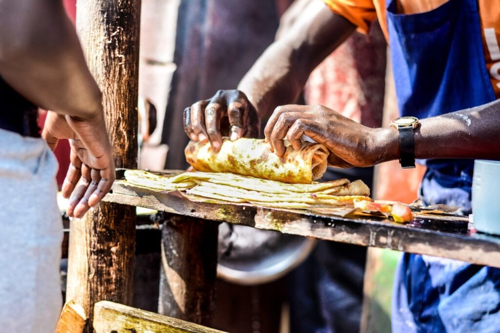 A man preparing fresh street food with vegetables and herbs