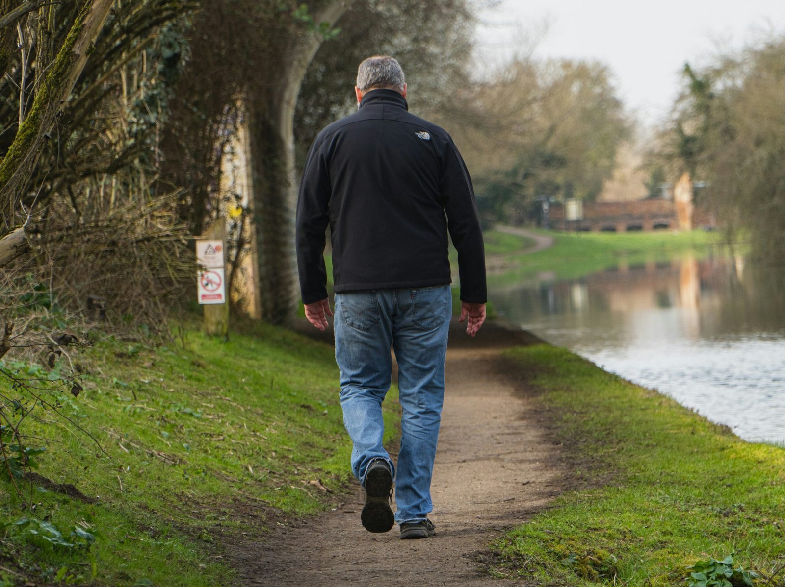A man walking outdoors, staying active as part of a healthy routine