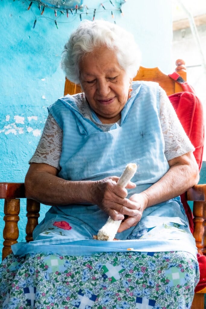 Latina woman in her sixties working on a craft project at home in Veracruz, Mexico
