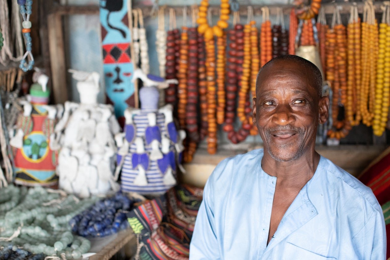 Smiling older Black man staying active and engaged at his shop