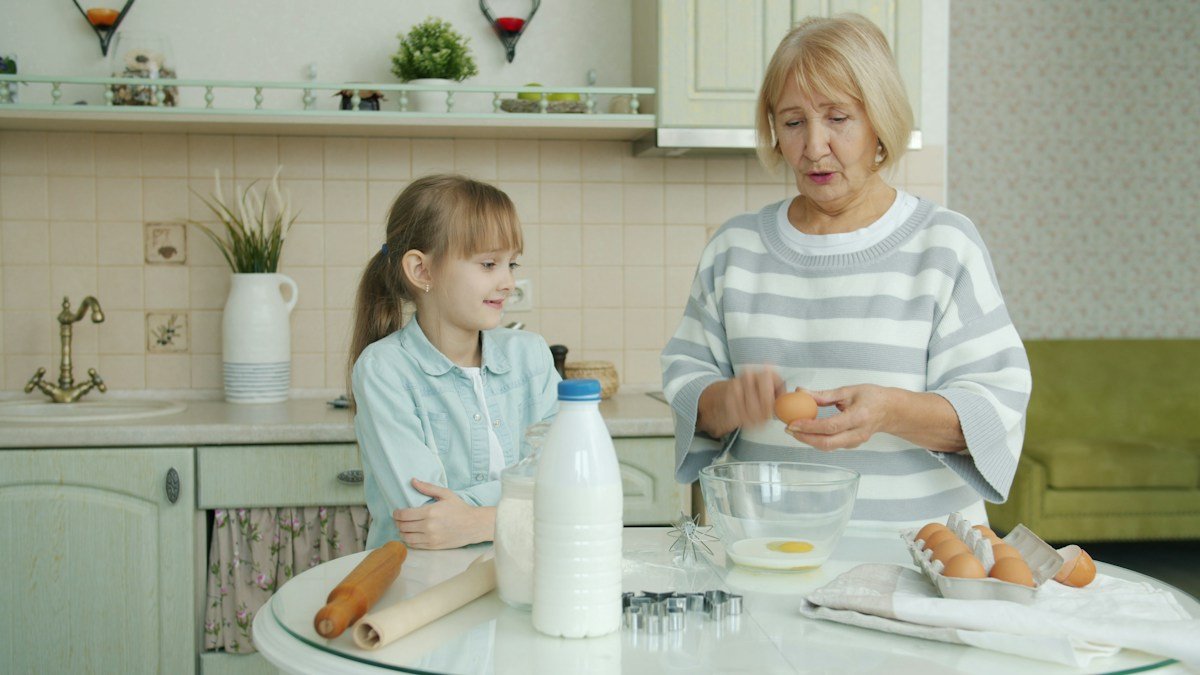 Senior woman cooking in her kitchen, preparing a protein and calcium-rich meal