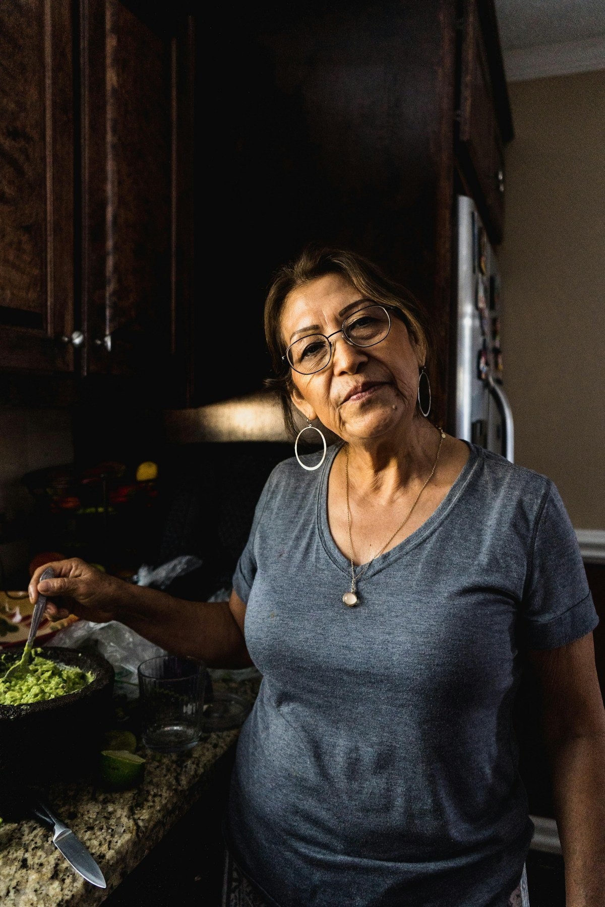 An older woman preparing a home-cooked meal in her kitchen