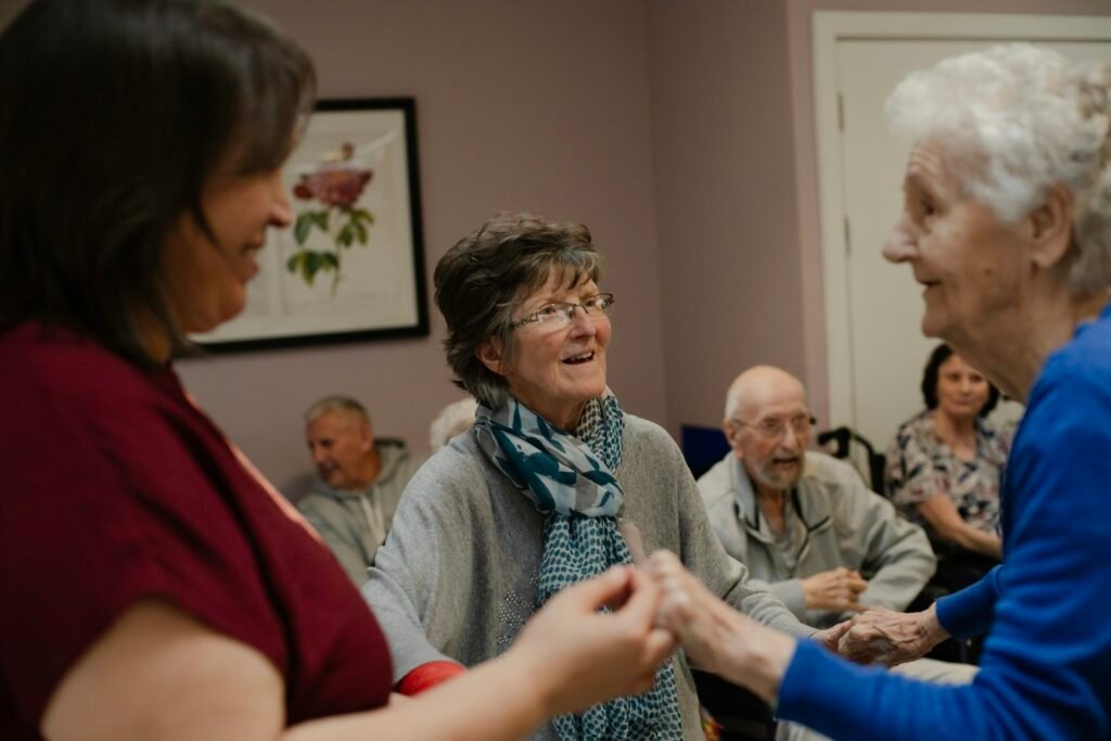 Older adults talking and laughing together at an indoor social gathering
