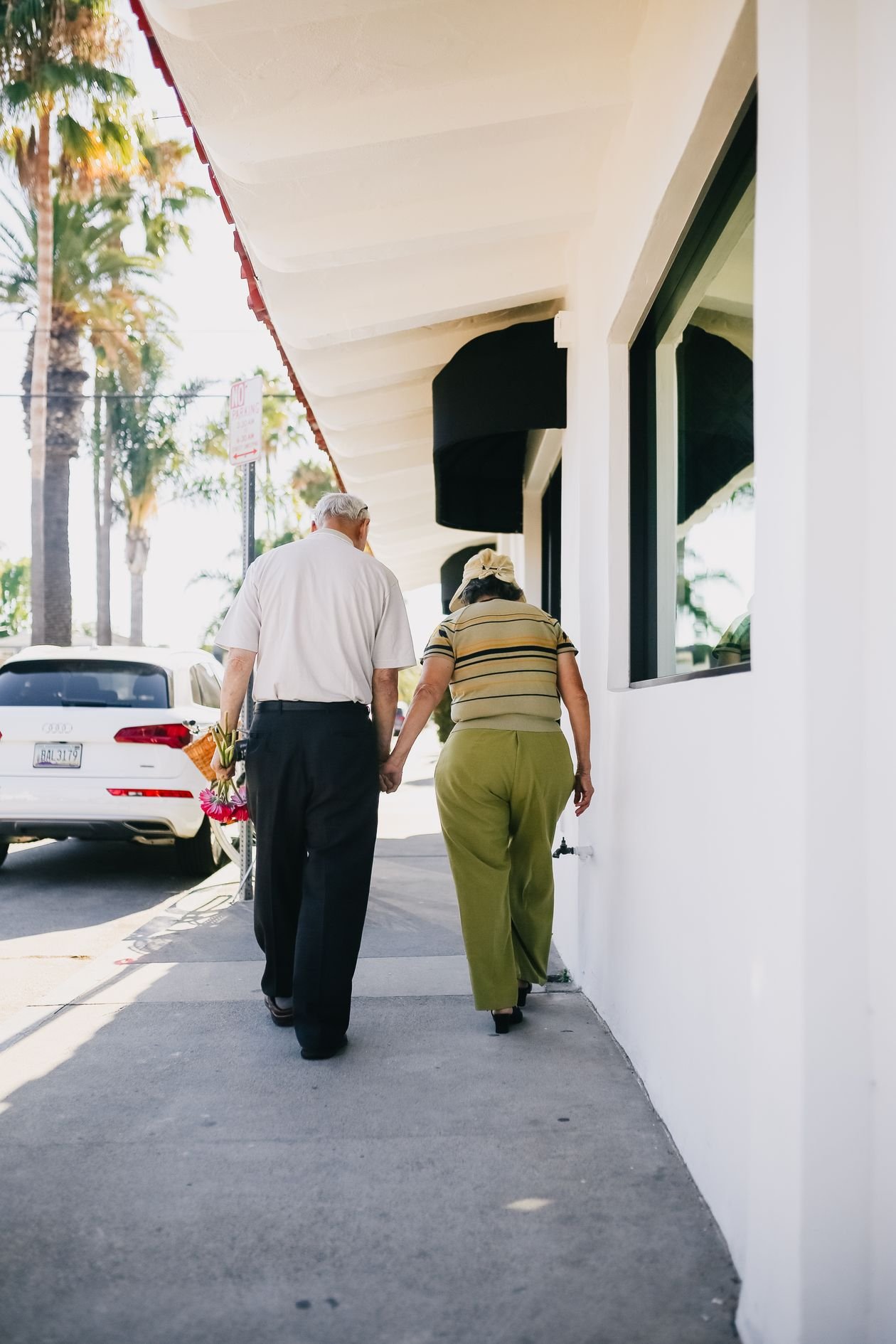 Senior couple walking together outdoors holding hands